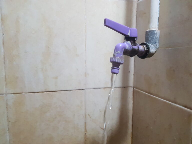 Flowing Water from Purple Faucet
