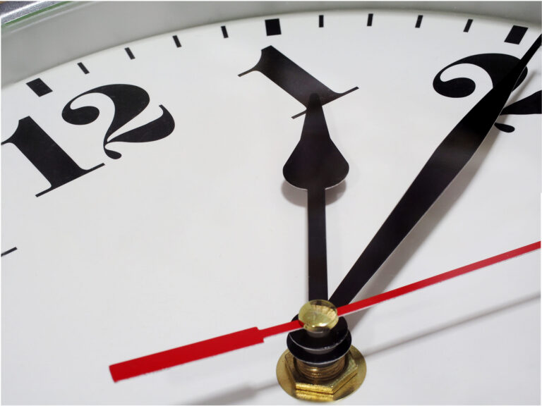 Closeup needle of analog clock white background Arabic number