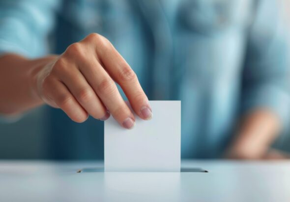 Person Casting Ballot In Election